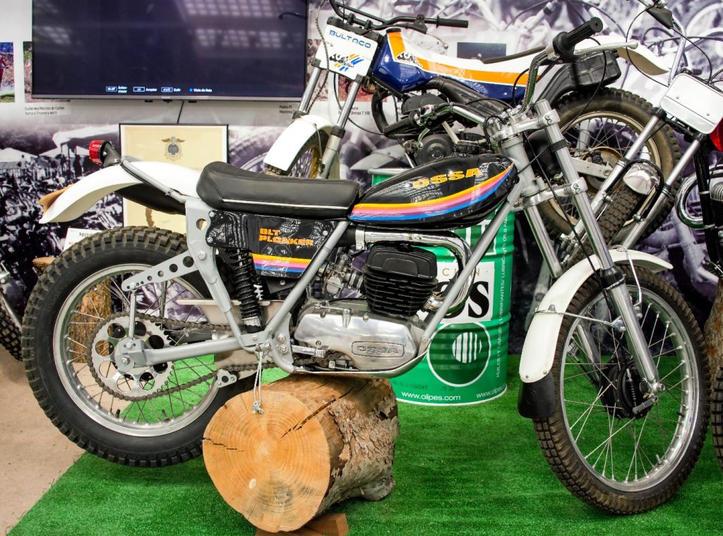 Motorbike parked on top of a log of wood